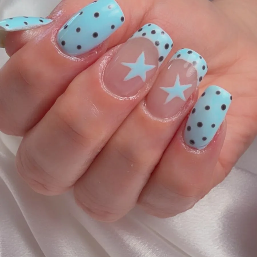 Baby blue square acrylic nails with polka dots and star accents at Yudy's Queen Nails in Palm Beach Gardens