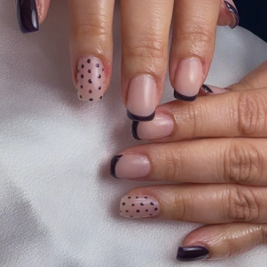 Builder gel nails with black French tips and polka dot accents at Yudy's Queen Nails in Palm Beach Gardens