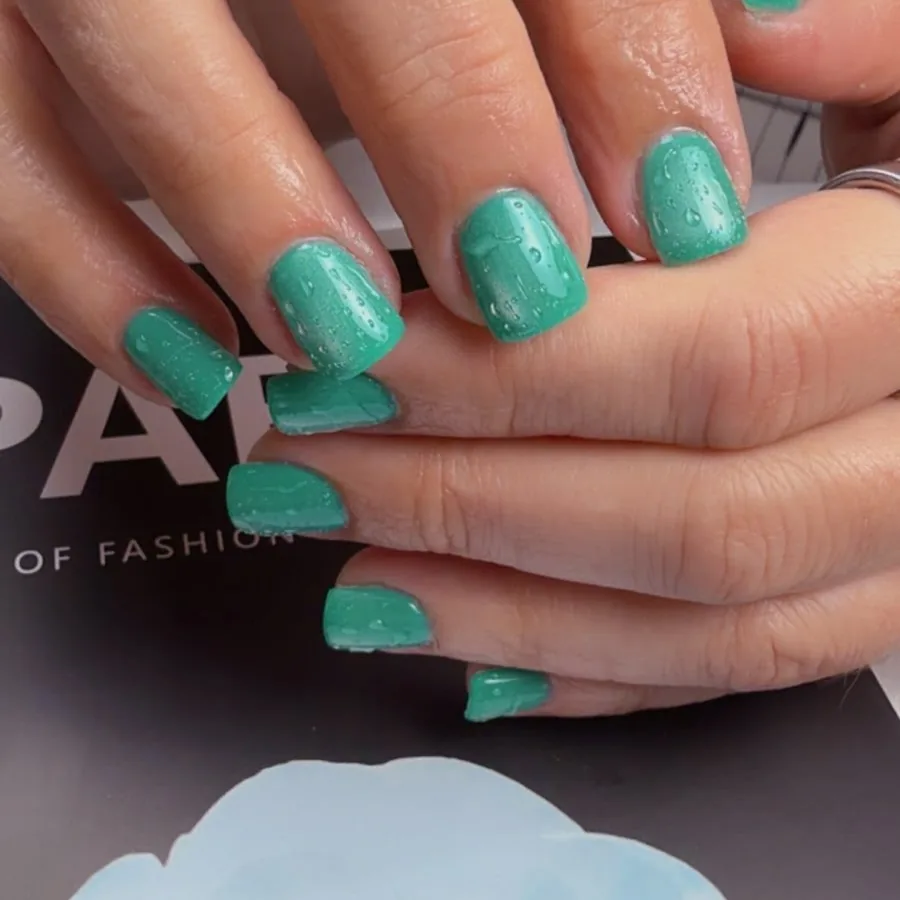 Short square dip powder nails in shimmering mint green at Yudy's Queen Nails in Palm Beach Gardens