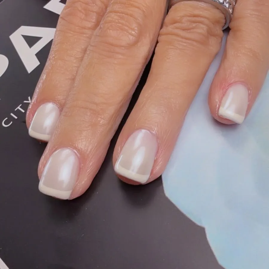 Short square dip powder nails in a sheer pearl finish at Yudy's Queen Nails in Palm Beach Gardens